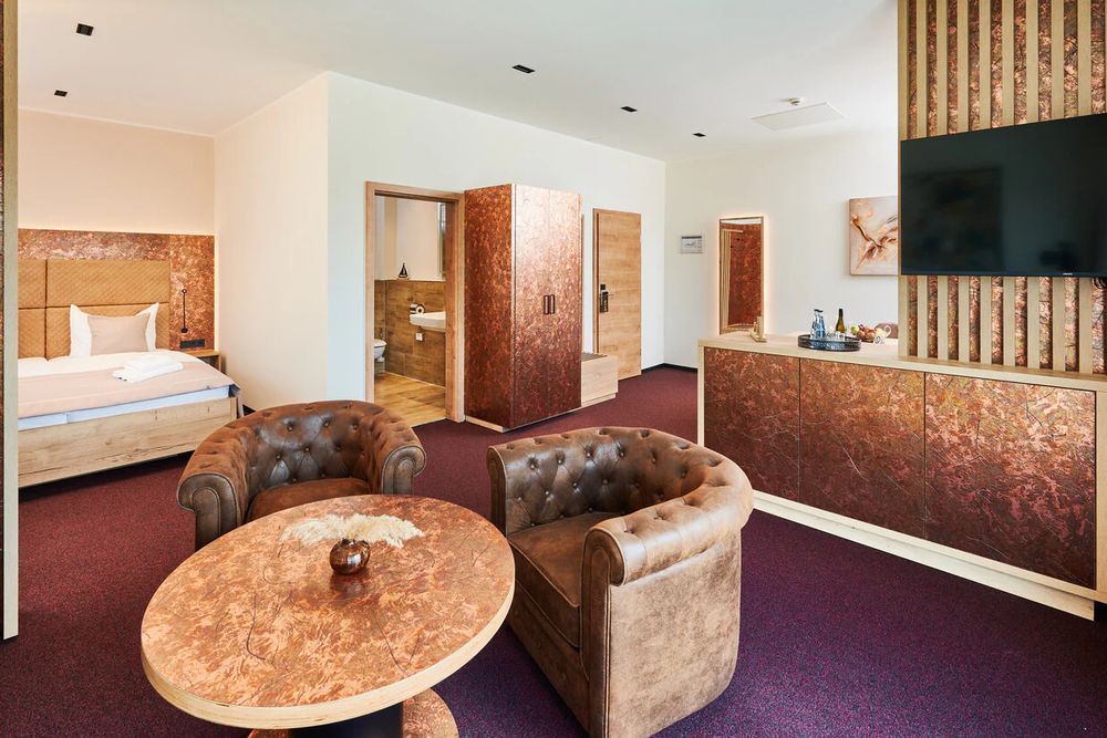 Chesterfield-Sessel und Holztisch in der Familiensuite